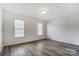Cozy bedroom with two windows, neutral paint, and vinyl flooring at 10434 Henbane Ct, Charlotte, NC 28213