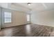 Spacious bedroom with a tray ceiling, neutral paint, and vinyl flooring at 10434 Henbane Ct, Charlotte, NC 28213