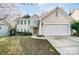 Traditional two-story home featuring a front lawn and two-car garage at 10434 Henbane Ct, Charlotte, NC 28213