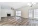 Bright living room with gas fireplace and a ceiling fan at 10434 Henbane Ct, Charlotte, NC 28213