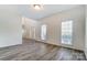 Bright living room with gray wood floors and natural light at 10434 Henbane Ct, Charlotte, NC 28213