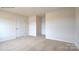 Carpeted bedroom featuring neutral walls, ceiling light, and multiple doors at 1059 Horizon St, Chester, SC 29706