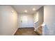 Inviting entryway featuring wood-look floors, a staircase, and a brightly lit entrance door at 1059 Horizon St, Chester, SC 29706