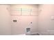 A utilitarian laundry room offering a storage shelf, utility connections, and a clean aesthetic at 1059 Horizon St, Chester, SC 29706