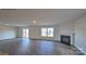 Bright living room showcasing hard wood floors, a cozy fireplace, and natural light from large windows at 1059 Horizon St, Chester, SC 29706