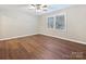 Cozy bedroom boasts window with natural light, providing warmth to the hardwood floors at 107 S Laurel Ave # 101A, Charlotte, NC 28207