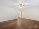Bright bedroom featuring modern ceiling fan, hardwood floors, and closet access at 107 S Laurel Ave # 101A, Charlotte, NC 28207