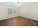 Bright bedroom boasts window with natural light, providing warmth to the hardwood floors at 107 S Laurel Ave # 101A, Charlotte, NC 28207