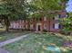 Charming brick apartment building featuring mature trees and manicured lawn at 107 S Laurel Ave # 101A, Charlotte, NC 28207