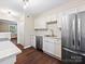 Bright kitchen features stainless steel appliances, white cabinets and subway tile backsplash at 107 S Laurel Ave # 101A, Charlotte, NC 28207