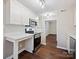 Modern kitchen boasts stainless steel appliances, white cabinets and bar-top counter at 107 S Laurel Ave # 101A, Charlotte, NC 28207