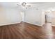 Open living area with hardwood floors, ceiling fan, and bright, neutral paint at 107 S Laurel Ave # 101A, Charlotte, NC 28207
