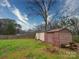 Fenced backyard featuring two storage sheds and a large mature tree at 1115 Kelly Rd, Mount Holly, NC 28120