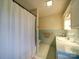 Bathroom with blue tiling, white cabinets, walk-in shower with curtain and tile flooring at 1115 Kelly Rd, Mount Holly, NC 28120