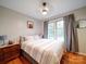 Bright bedroom with hardwood floors, a ceiling fan, and a large window with natural light at 1115 Kelly Rd, Mount Holly, NC 28120