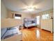 Bright bedroom features 2 bunk beds, wood floors, 2 windows, white walls, and a ceiling fan at 1115 Kelly Rd, Mount Holly, NC 28120