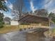 Carport on a concrete driveway with a storage shed in the background and lush green lawn at 1115 Kelly Rd, Mount Holly, NC 28120