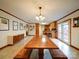 Inviting dining area with large wooden table, chandelier, and view of kitchen and doorway at 1115 Kelly Rd, Mount Holly, NC 28120