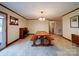 Bright dining room with large wooden table, fireplace, and access to the outdoor patio at 1115 Kelly Rd, Mount Holly, NC 28120
