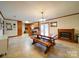 Bright dining area with a decorative fireplace and an adjacent kitchen at 1115 Kelly Rd, Mount Holly, NC 28120