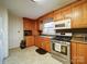 Charming kitchen features wooden cabinets, stainless steel appliances, and a window over the sink at 1115 Kelly Rd, Mount Holly, NC 28120