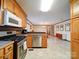 Spacious kitchen with ample cabinetry and a view into the adjacent dining and living area at 1115 Kelly Rd, Mount Holly, NC 28120