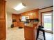 Functional kitchen featuring ample wood cabinetry, a breakfast bar, and easy access to the outdoors at 1115 Kelly Rd, Mount Holly, NC 28120