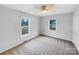 Bright bedroom features a ceiling fan and two windows offering natural light at 1125 Twin Lakes Rd, Rock Hill, SC 29732