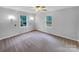 Bright bedroom features a ceiling fan and two windows offering natural light at 1125 Twin Lakes Rd, Rock Hill, SC 29732