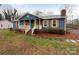 Charming single-story home features a welcoming front porch, shutters, and a beautifully maintained lawn at 1125 Twin Lakes Rd, Rock Hill, SC 29732