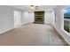 Spacious living room with fireplace, ceiling fan, neutral carpet, and a large window at 1125 Twin Lakes Rd, Rock Hill, SC 29732