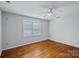 This bedroom features hardwood floors and a large window, offering plenty of natural light at 11431 Howell Center Dr, Charlotte, NC 28227