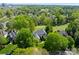Aerial view of a beautiful estate situated on a golf course with lush green landscaping and mature trees at 12014 James Jack Ln, Charlotte, NC 28277