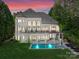 Luxurious backyard features a sparkling pool, spa, elegant patio furniture, and lush landscaping at 12014 James Jack Ln, Charlotte, NC 28277
