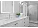 Modern bathroom with double vanity, quartz countertop, and glass-enclosed shower at 12014 James Jack Ln, Charlotte, NC 28277