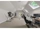 Spacious bonus room featuring neutral carpet, vaulted ceilings with skylights and ceiling fan, perfect for workout or recreation at 12014 James Jack Ln, Charlotte, NC 28277