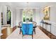 Dining room with elegant wainscoting, modern light fixture and view to large garden at 12014 James Jack Ln, Charlotte, NC 28277