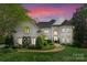 Elegant white brick home with manicured landscaping and a charming brick walkway leading to the grand entrance at 12014 James Jack Ln, Charlotte, NC 28277
