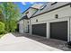 Beautiful modern home with a spacious three-car garage, black doors and light fixtures, and a well-manicured yard at 12014 James Jack Ln, Charlotte, NC 28277
