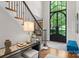 Elegant foyer with grand staircase, hardwood floors, and large arched window providing natural light at 12014 James Jack Ln, Charlotte, NC 28277