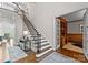 Spacious foyer featuring a staircase with black iron railing and view into the living room at 12014 James Jack Ln, Charlotte, NC 28277