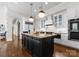 Gourmet kitchen features white cabinets, a large island, and modern appliances at 12014 James Jack Ln, Charlotte, NC 28277