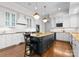 Stylish kitchen with white cabinets, granite countertops, and dark island with seating at 12014 James Jack Ln, Charlotte, NC 28277