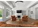 Cozy living room with a fireplace, built-in shelves, comfortable seating, and plenty of natural light at 12014 James Jack Ln, Charlotte, NC 28277
