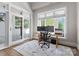 Bright home office with natural light, a desk with monitors, and an area rug at 12014 James Jack Ln, Charlotte, NC 28277