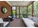 Relaxing screened porch features wood paneling, ceiling fan, and cozy wicker furniture overlooking the landscaped backyard at 12014 James Jack Ln, Charlotte, NC 28277