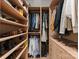 Organized walk-in closet with custom shelving, drawers, and hanging rods for ample storage space at 12014 James Jack Ln, Charlotte, NC 28277