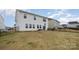 Spacious backyard with a black metal fence and a view of the house's rear at 129 Doncaster Dr, Mooresville, NC 28115