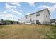 A large backyard featuring a black metal fence and a view of the house at 129 Doncaster Dr, Mooresville, NC 28115