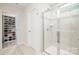 Sleek bathroom featuring glass shower, adjacent to a large shoe closet for organized storage at 129 Doncaster Dr, Mooresville, NC 28115